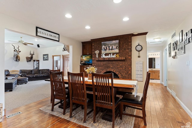 712 S 6150 W, Ogden, UT 84404 - dining space featuring light hardwood / wood-style floors, ceiling fan, and a fireplace