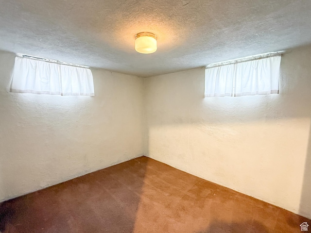 5840 S 2625 W, Roy, UT 84067 - carpeted empty room featuring a textured wall, a healthy amount of sunlight, and a textured ceiling