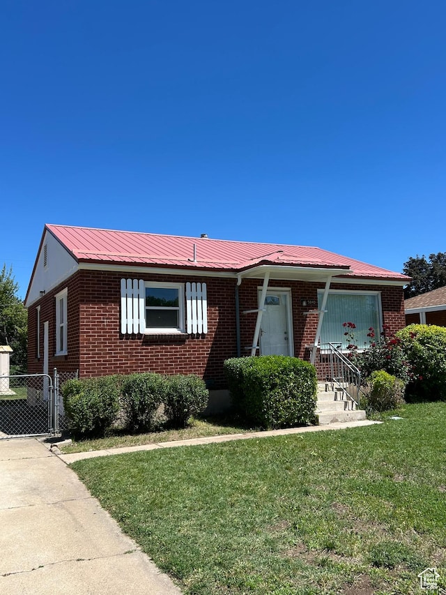 5840 S 2625 W, Roy, UT 84067 - single story home with brick siding, a front lawn, and metal roof