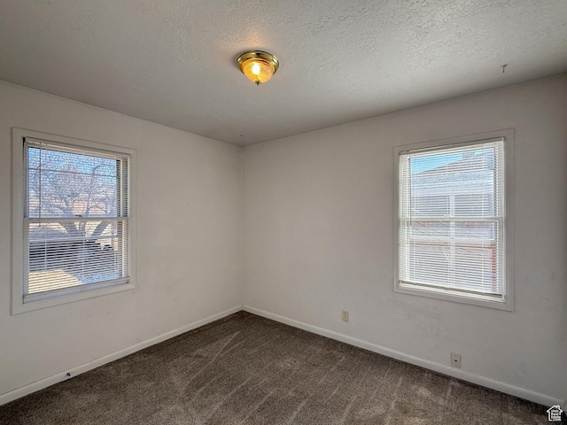 5840 S 2625 W, Roy, UT 84067 - empty room with plenty of natural light, baseboards, dark carpet, and a textured ceiling