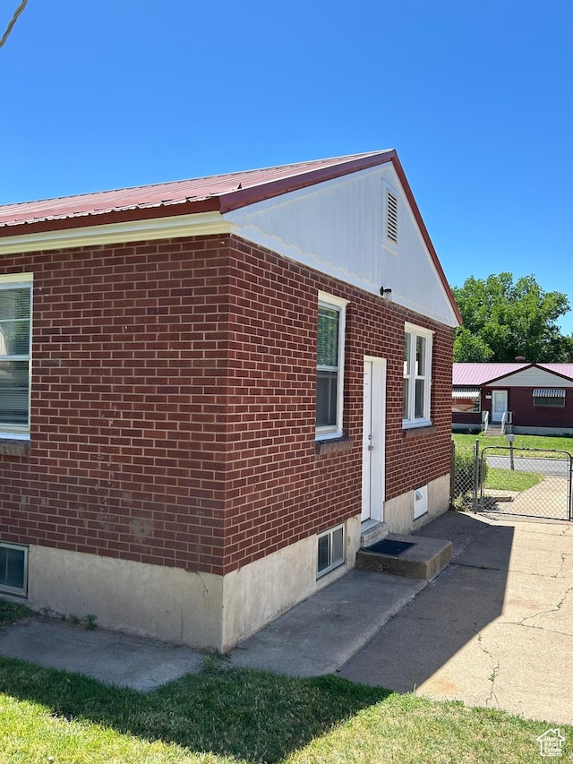 5840 S 2625 W, Roy, UT 84067 - view of side of property with brick siding and metal roof