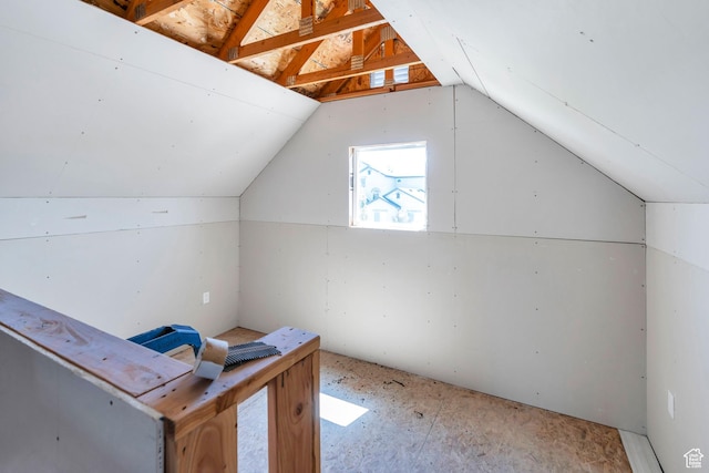additional living space featuring vaulted ceiling