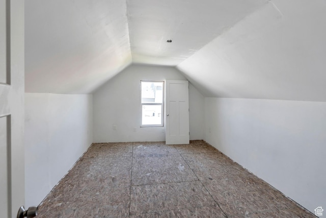 additional living space featuring vaulted ceiling