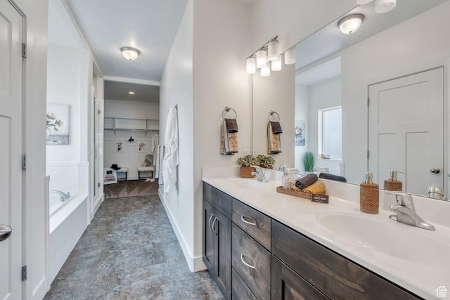 bathroom with vanity and a tub