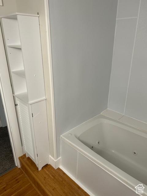 bathroom featuring hardwood / wood-style flooring and a bathing tub