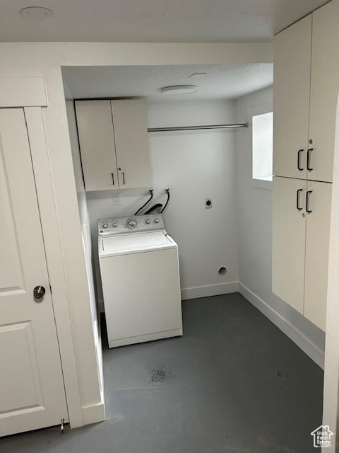 laundry room featuring washer / clothes dryer and cabinets
