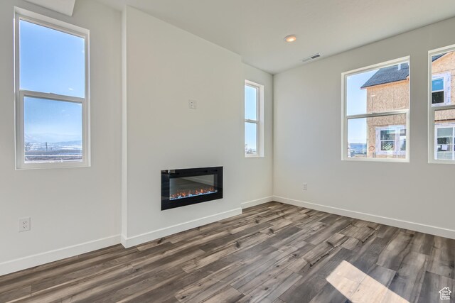 unfurnished living room with dark hardwood / wood-style flooring