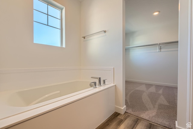 bathroom featuring a tub and hardwood / wood-style flooring