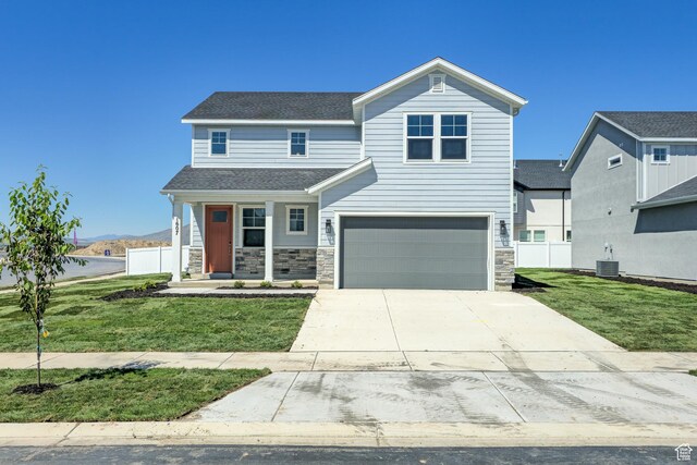 1607 N 800 W, Salem, UT 84653 - view of front of house featuring an attached garage, central air condition unit, concrete driveway, roof with shingles, and stone siding
