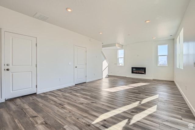 unfurnished living room with wood-type flooring