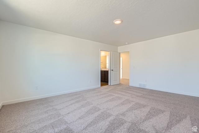 empty room featuring light colored carpet