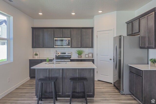 1607 N 800 W, Salem, UT 84653 - kitchen with appliances with stainless steel finishes, light countertops, dark brown cabinetry, backsplash, and recessed lighting