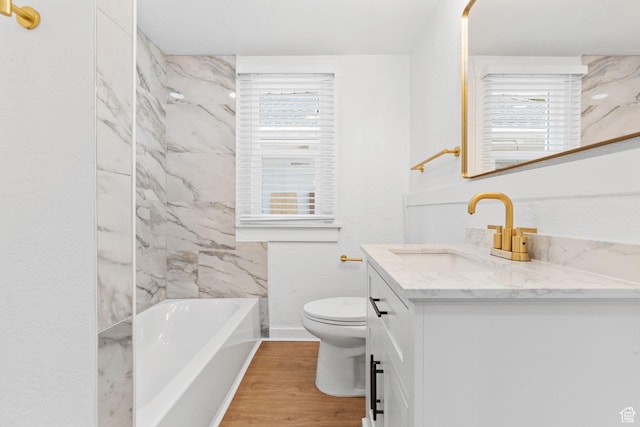 789 27th St, Ogden, UT 84403 - bathroom with wood-type flooring, a healthy amount of sunlight, vanity, and toilet