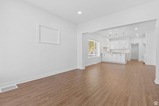 789 27th St, Ogden, UT 84403 - unfurnished living room featuring sink and light wood-type flooring