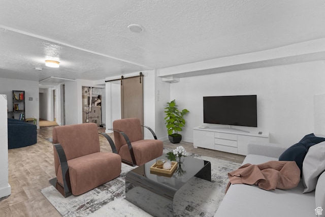 789 27th St, Ogden, UT 84403 - living room with a barn door, a textured ceiling, and light hardwood / wood-style flooring