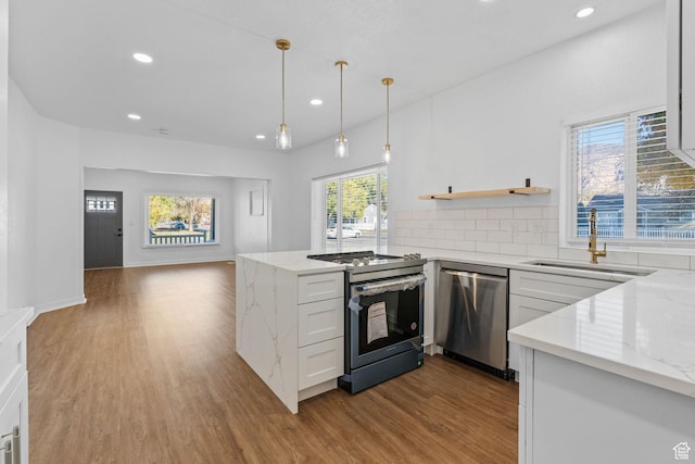 789 27th St, Ogden, UT 84403 - kitchen featuring light stone counters, light hardwood / wood-style floors, white cabinets, and appliances with stainless steel finishes