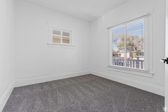 789 27th St, Ogden, UT 84403 - empty room featuring a healthy amount of sunlight and dark carpet