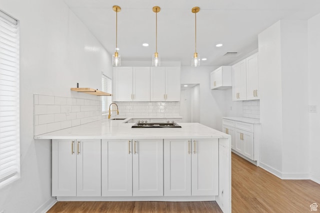 789 27th St, Ogden, UT 84403 - kitchen featuring white cabinetry, light stone counters, pendant lighting, and kitchen peninsula