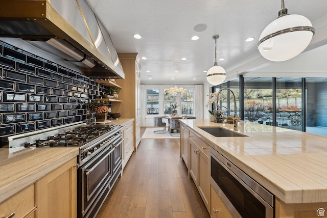 2905 E Denmark Dr, Cottonwood Heights, UT 84121 - kitchen with light brown cabinets, exhaust hood, stainless steel microwave, a sink, and range with two ovens