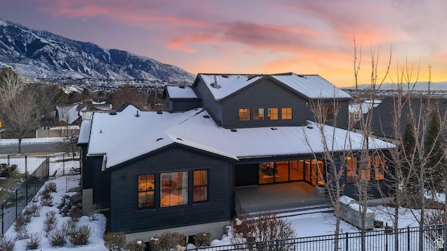 2905 E Denmark Dr, Cottonwood Heights, UT 84121 - snow covered house with fence and a mountain view