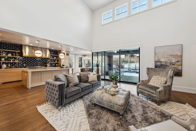 2905 E Denmark Dr, Cottonwood Heights, UT 84121 - living area featuring baseboards, wood finished floors, and a towering ceiling