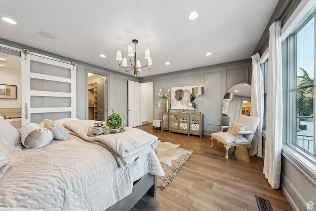 2905 E Denmark Dr, Cottonwood Heights, UT 84121 - bedroom featuring recessed lighting, arched walkways, a notable chandelier, and a decorative wall