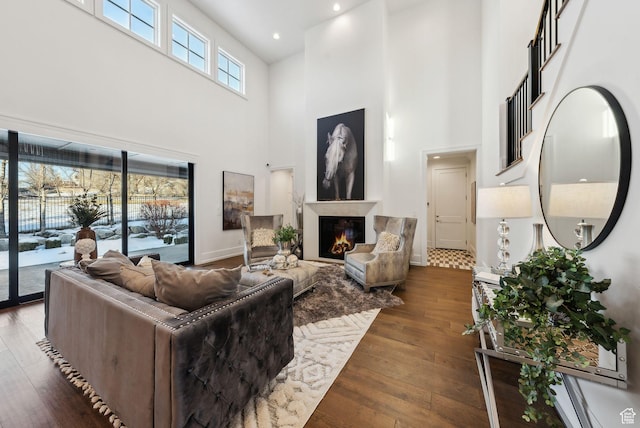 2905 E Denmark Dr, Cottonwood Heights, UT 84121 - living area with a high ceiling, recessed lighting, wood-type flooring, baseboards, and a lit fireplace