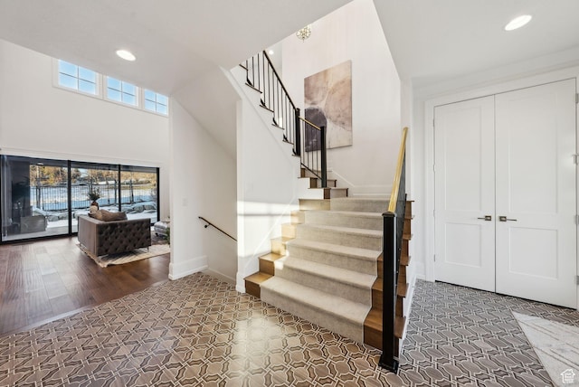 2905 E Denmark Dr, Cottonwood Heights, UT 84121 - stairway featuring recessed lighting, a towering ceiling, and baseboards
