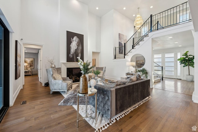 2905 E Denmark Dr, Cottonwood Heights, UT 84121 - living area with a towering ceiling, stairs, visible vents, and wood finished floors