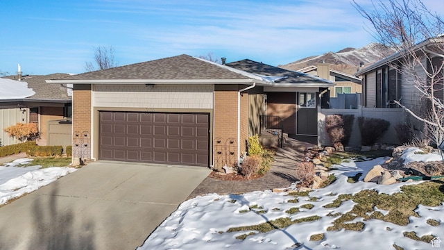 ranch-style home featuring a mountain view and a garage