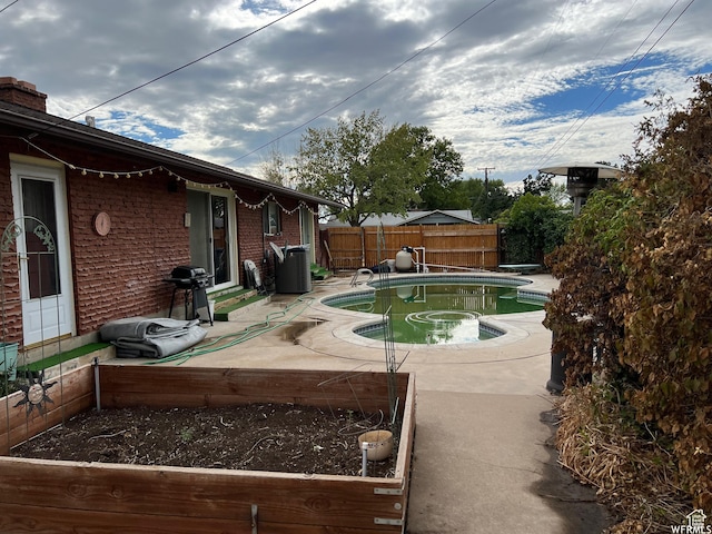 view of pool featuring a grill and a patio area