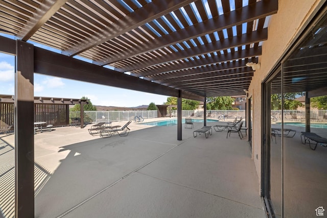 view of patio / terrace with fence, a pergola, and a community pool