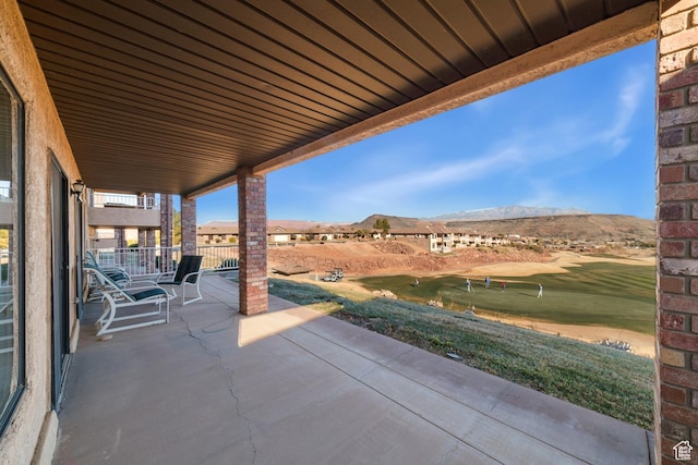 view of patio / terrace with golf course view and a mountain view