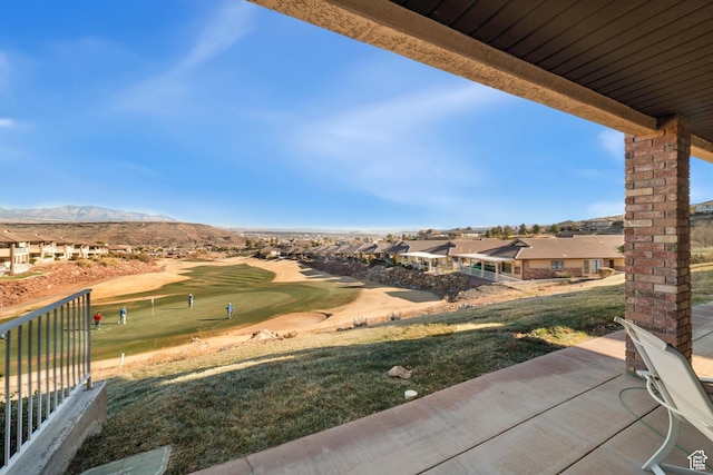 view of patio with a residential view, golf course view, and a mountain view