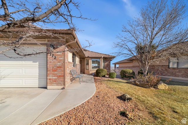 view of front of property with brick siding and an attached garage