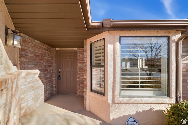 property entrance featuring brick siding