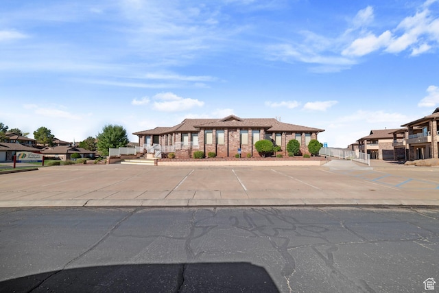 view of front facade featuring uncovered parking and a residential view