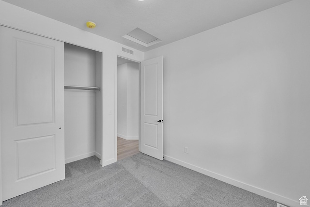 1162 N 375th St W Unit 22, Harrisville, UT 84404 - unfurnished bedroom featuring visible vents, baseboards, attic access, carpet flooring, and a closet