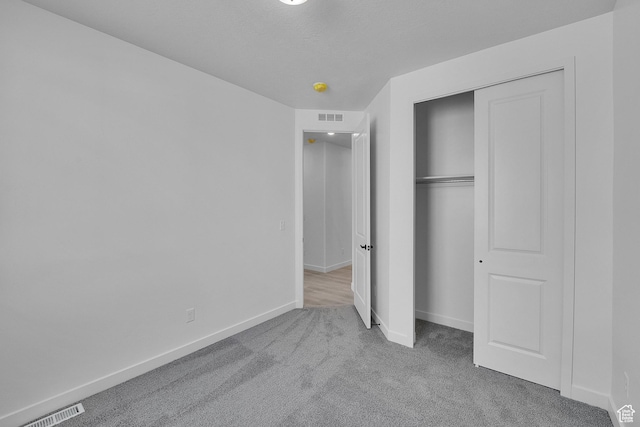 1162 N 375th St W Unit 22, Harrisville, UT 84404 - unfurnished bedroom featuring carpet flooring, baseboards, visible vents, and a closet