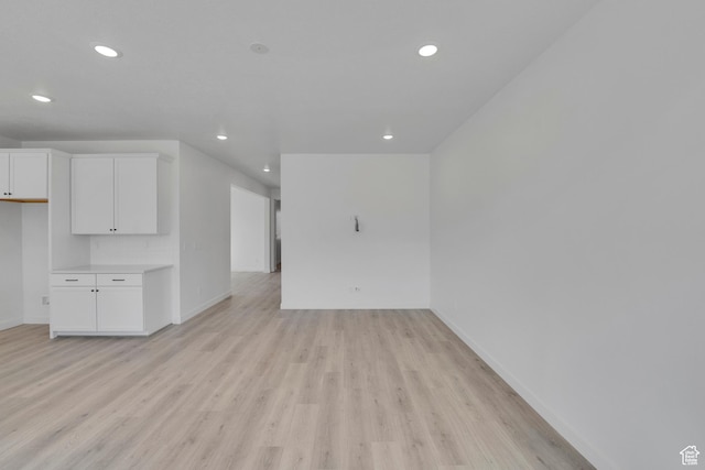 1162 N 375th St W Unit 22, Harrisville, UT 84404 - unfurnished living room with recessed lighting, baseboards, and light wood-style flooring