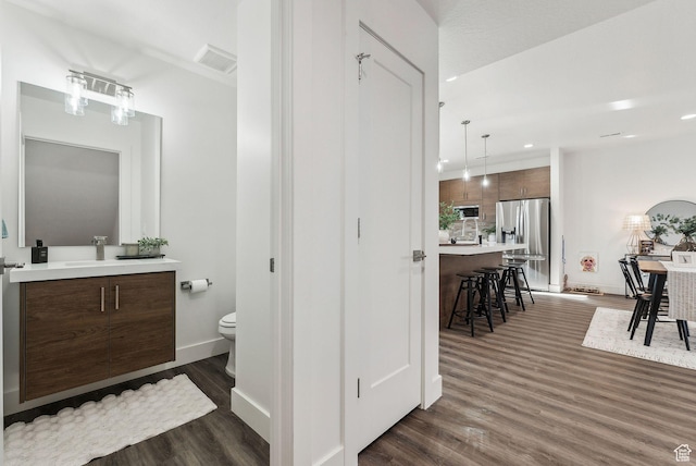 1618 S Main St Unit 2, Salt Lake City, UT 84115 - bathroom with hardwood / wood-style flooring, vanity, and toilet