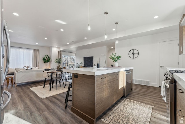 1618 S Main St Unit 2, Salt Lake City, UT 84115 - kitchen featuring appliances with stainless steel finishes, dark hardwood / wood-style floors, sink, and a center island with sink