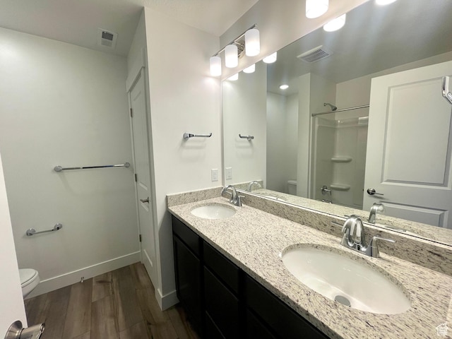 full bathroom with toilet, visible vents, and a sink