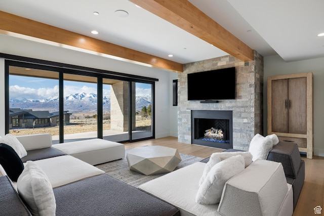 2066 E Oquirrh Mountain Cir, Heber City, UT 84032 - living room featuring a fireplace, beamed ceiling, wood finished floors, and baseboards