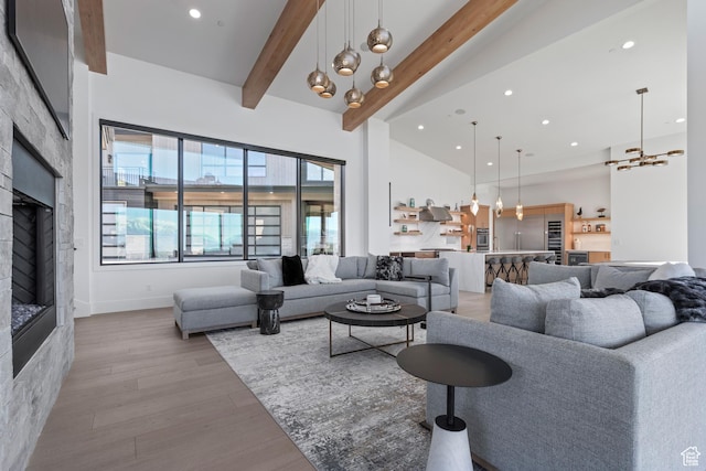 2066 E Oquirrh Mountain Cir, Heber City, UT 84032 - living room with beam ceiling, high vaulted ceiling, light wood-style flooring, recessed lighting, and a fireplace
