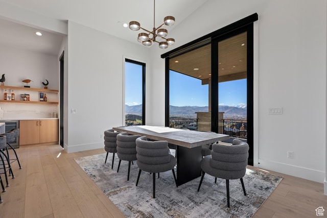 2066 E Oquirrh Mountain Cir, Heber City, UT 84032 - dining room featuring baseboards, light wood finished floors, recessed lighting, a notable chandelier, and a mountain view