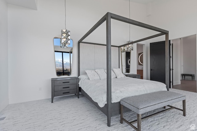 2066 E Oquirrh Mountain Cir, Heber City, UT 84032 - bedroom featuring wood finished floors, baseboards, and a towering ceiling