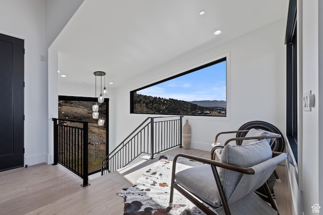 2066 E Oquirrh Mountain Cir, Heber City, UT 84032 - sitting room featuring an upstairs landing, baseboards, and wood finished floors