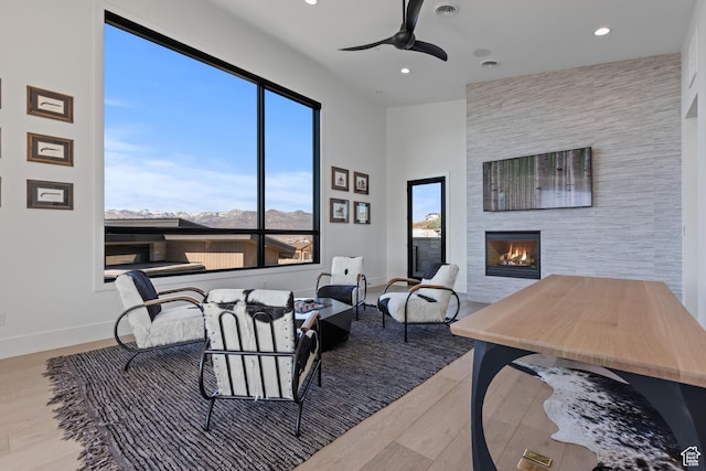 2066 E Oquirrh Mountain Cir, Heber City, UT 84032 - living room with wood finished floors, baseboards, recessed lighting, a fireplace, and ceiling fan