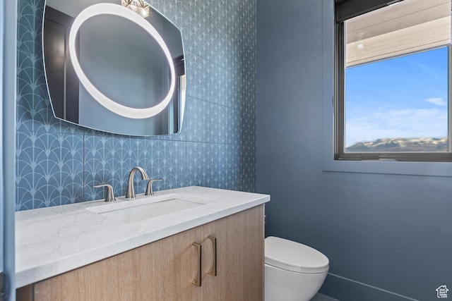 2066 E Oquirrh Mountain Cir, Heber City, UT 84032 - half bathroom featuring wallpapered walls, toilet, and vanity
